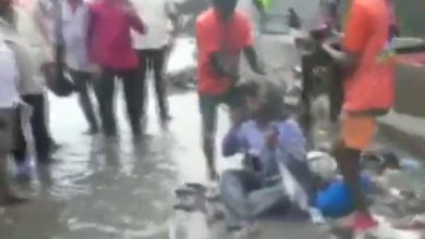 Mumbai Shiv Sena MLA from Chandivali, Dilip Lande makes a contractor sit on water logged road dump garbage