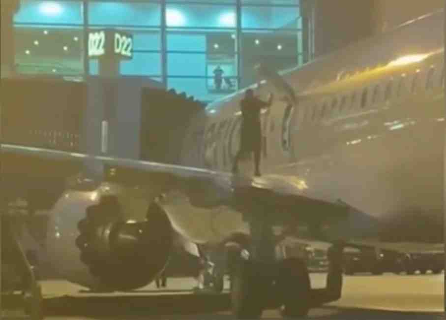 Airline passenger arrested after opening emergency exit and jumping on wing of plane at Miami airport,