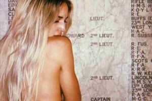 A women tourist naked topless at a war memorial