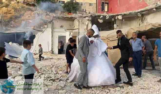 Wedding party on the rubble of a destroyed house, challenging the occupying enemy wedding party