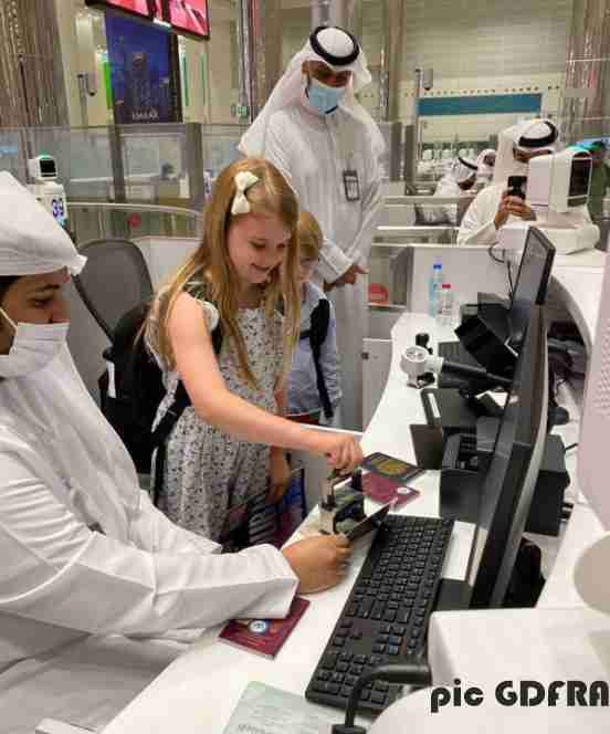 two british children stamp their own passports at dubai airport