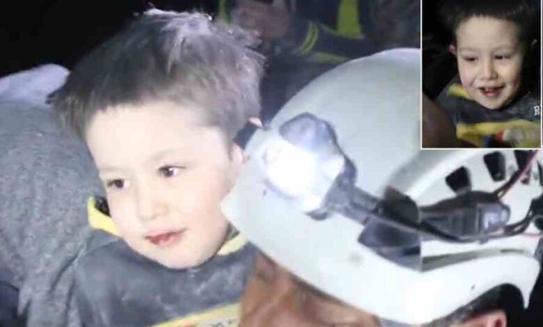 Syrian boy smiles after being pulled from the rubble