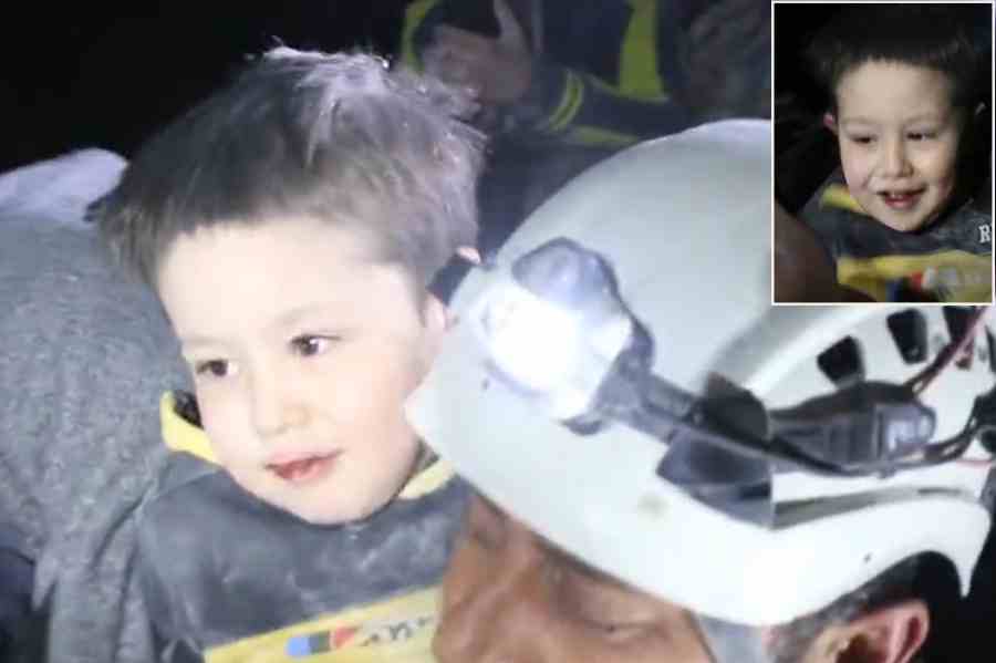 Syrian boy smiles after being pulled from the rubble