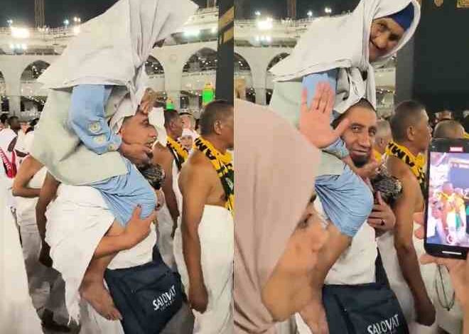video of an umrah pilgrim carrying his mother mother on shoulders during umrah