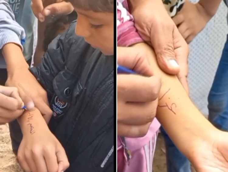 children in gaza writing their names on their arms