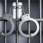 handcuffs hanging in jail cell arrest