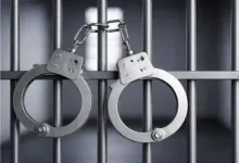 handcuffs hanging in jail cell arrest