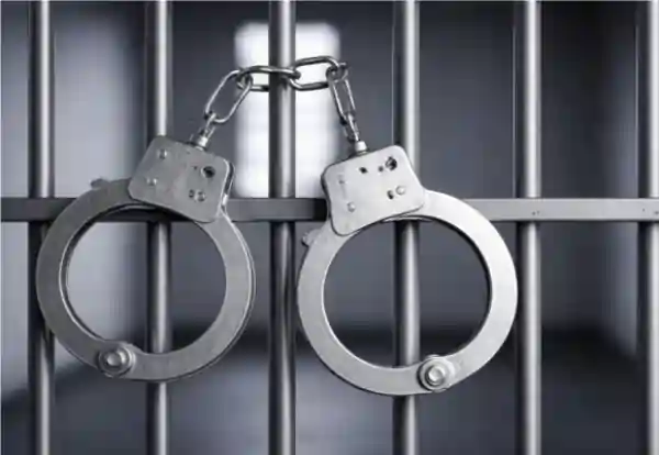 handcuffs hanging in jail cell arrest